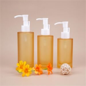 Cylinder clear glass bottle with white pump for lotion or serum